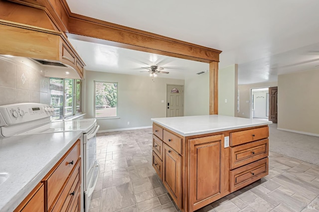 kitchen featuring electric range, open floor plan, light countertops, and baseboards