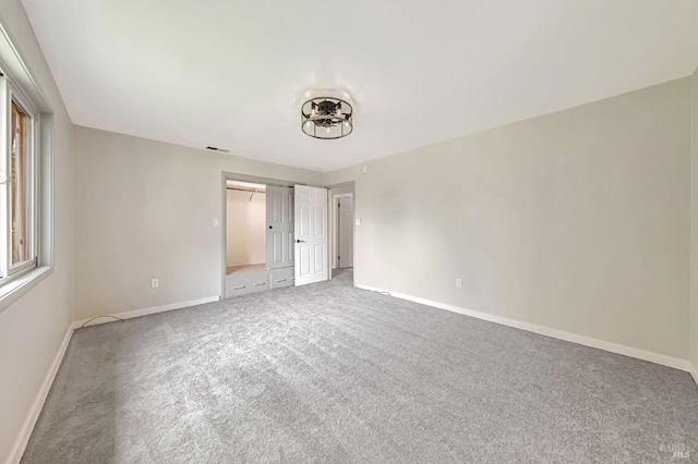 unfurnished bedroom with visible vents, a closet, baseboards, and carpet floors