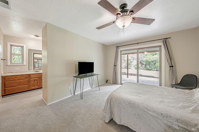 bedroom with a textured ceiling, visible vents, access to outside, and light carpet