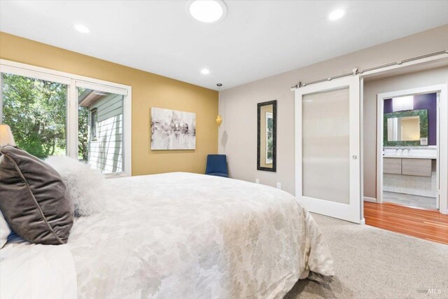 carpeted bedroom with recessed lighting