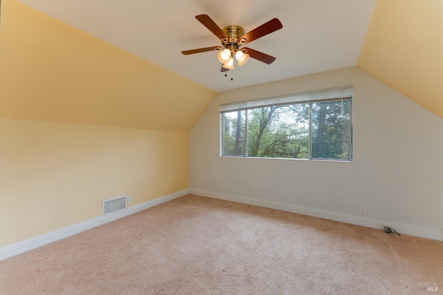 additional living space with visible vents, carpet flooring, ceiling fan, and lofted ceiling