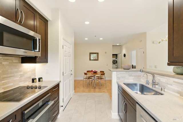 401 N Ave Unit 310, San Rafael, CA 94903 - kitchen with light countertops, black electric cooktop, stainless steel microwave, wall oven, and tasteful backsplash