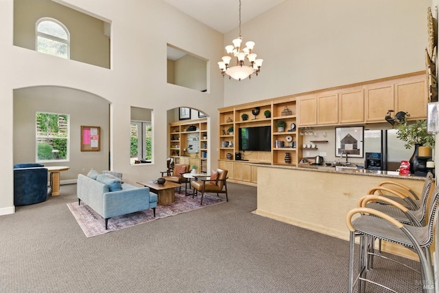401 N Ave Unit 310, San Rafael, CA 94903 - living area featuring dark colored carpet, a notable chandelier, a healthy amount of sunlight, and a towering ceiling