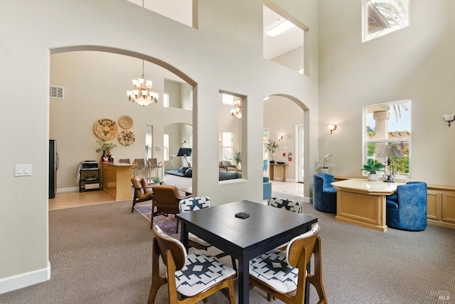 401 N Ave Unit 310, San Rafael, CA 94903 - dining space with visible vents, light colored carpet, arched walkways, an inviting chandelier, and a high ceiling