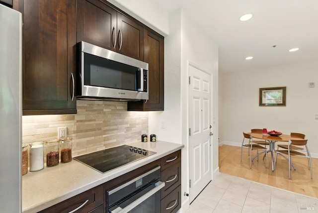 401 N Ave Unit 310, San Rafael, CA 94903 - kitchen with decorative backsplash, dark brown cabinetry, dishwasher, a sink, and lofted ceiling