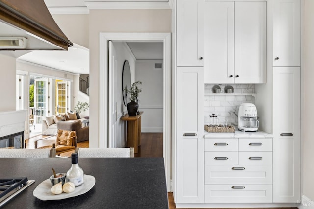 18 Egret Way, Mill Valley, CA 94941 - kitchen featuring wood finished floors, decorative backsplash, ornamental molding, and white cabinets
