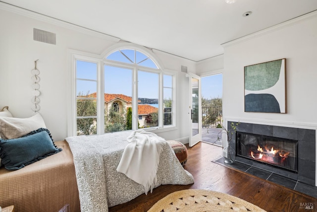 18 Egret Way, Mill Valley, CA 94941 - bedroom featuring wood finished floors, a tile fireplace, access to exterior, visible vents, and crown molding