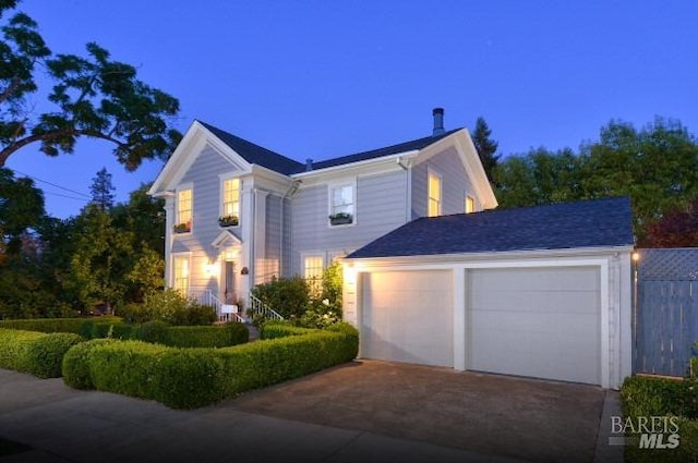 traditional home featuring a garage and driveway