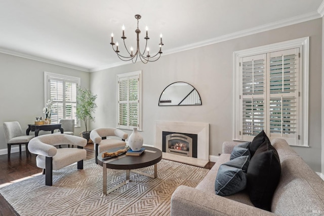 living area with an inviting chandelier, wood finished floors, and crown molding