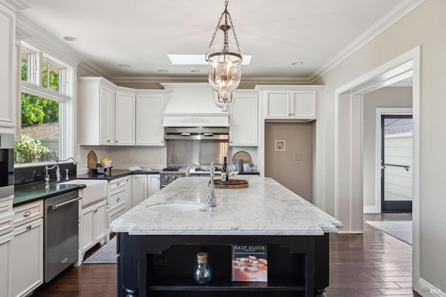 kitchen with a kitchen island with sink, a sink, open shelves, stainless steel dishwasher, and white cabinets