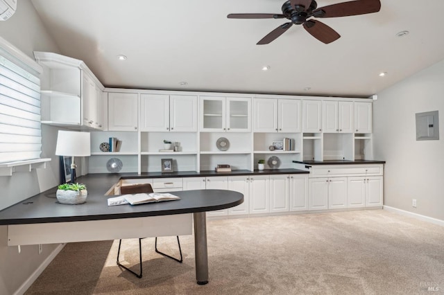 kitchen featuring open shelves, white cabinets, dark countertops, electric panel, and baseboards