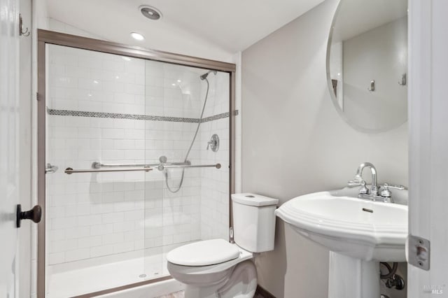 bathroom with recessed lighting, a shower stall, toilet, and a sink