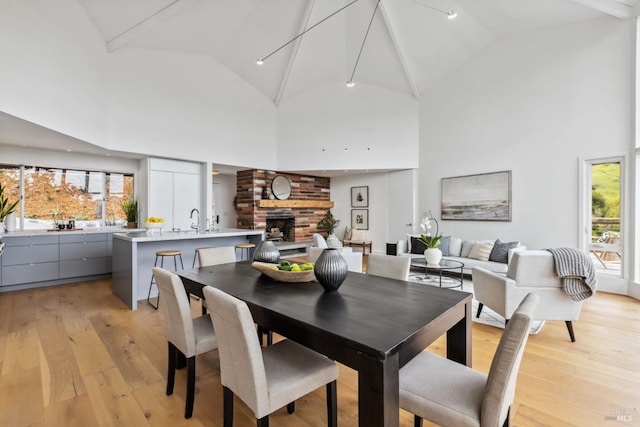 28 Timothy Ave, San Anselmo, CA 94960 - dining space with light wood-type flooring, plenty of natural light, high vaulted ceiling, and a large fireplace