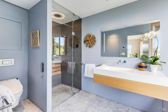 full bathroom featuring a stall shower, toilet, and vanity