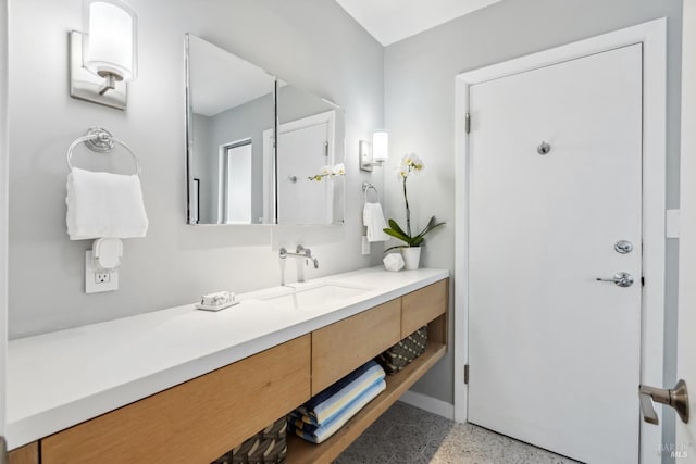 bathroom with vanity and baseboards
