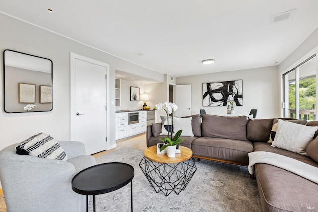 living area with visible vents and light wood finished floors