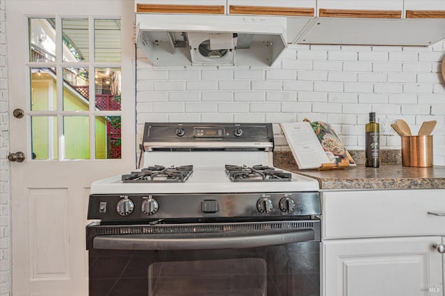 337 Madrone Ave, Larkspur, CA 94939 - kitchen with gas stove, white cabinetry, dark countertops, and tasteful backsplash