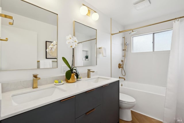bathroom featuring double vanity, toilet, a sink, and shower / tub combo with curtain