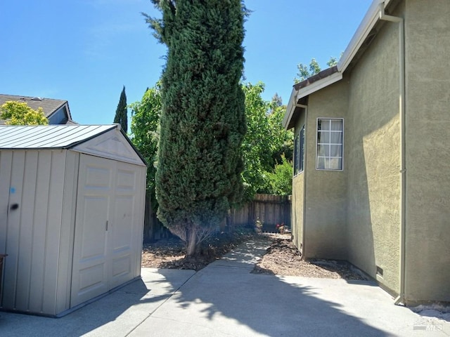 2998 Burl Ct, Fairfield, CA 94533 - view of property exterior with a patio area, fence, a storage unit, an outdoor structure, and stucco siding