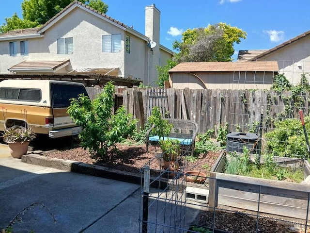 view of yard with fence and a vegetable garden