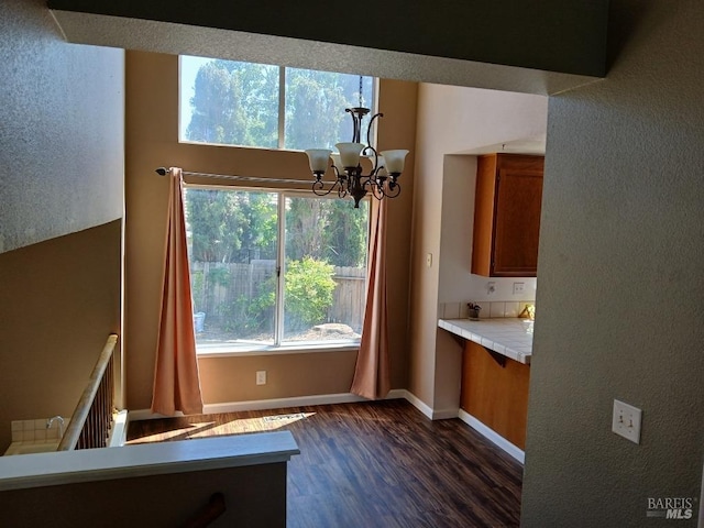 2998 Burl Ct, Fairfield, CA 94533 - unfurnished dining area with dark wood-type flooring, a chandelier, and baseboards