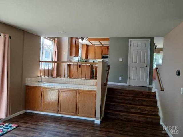 2998 Burl Ct, Fairfield, CA 94533 - kitchen featuring tile countertops, dark wood-style flooring, baseboards, and brown cabinetry