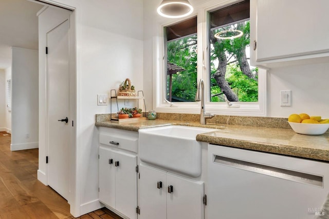 interior space featuring vanity, baseboards, and wood finished floors