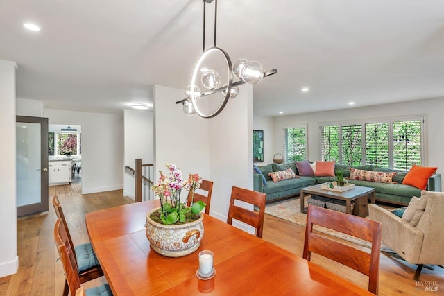 dining area with light wood-type flooring, recessed lighting, baseboards, and a healthy amount of sunlight