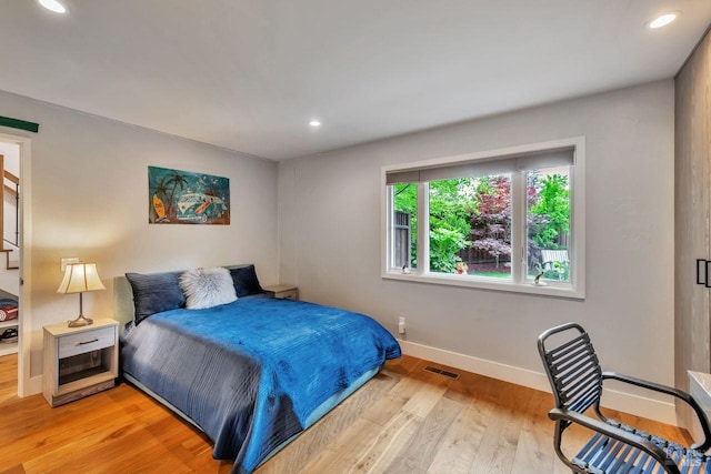 bedroom with visible vents, recessed lighting, baseboards, and light wood-type flooring