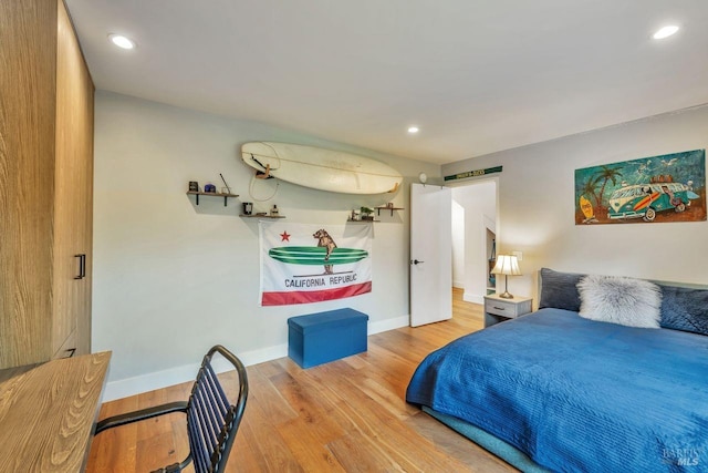 bedroom featuring baseboards, recessed lighting, and wood finished floors