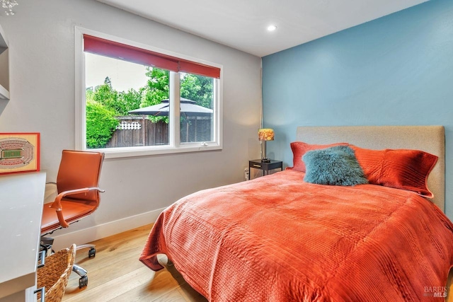 bedroom featuring baseboards, recessed lighting, and wood finished floors