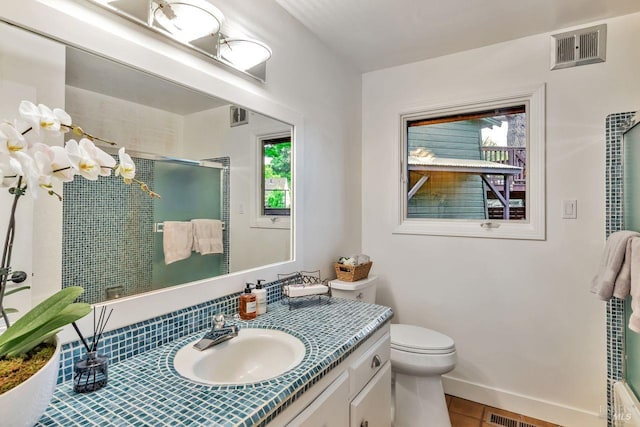full bathroom featuring visible vents, vanity, toilet, tile patterned floors, and a stall shower
