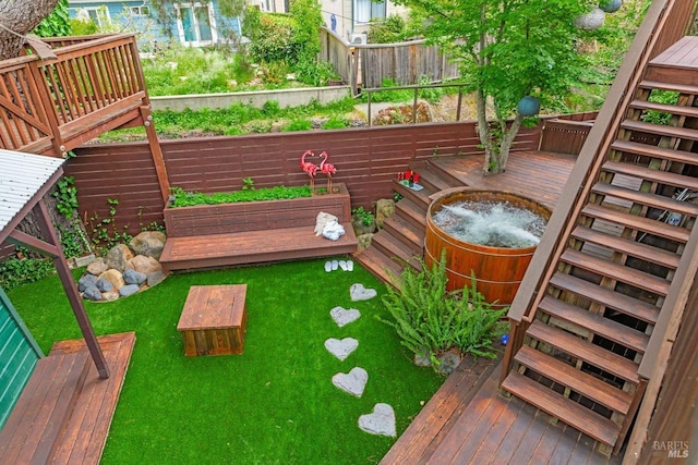 view of yard with fence, stairs, a garden, and a wooden deck