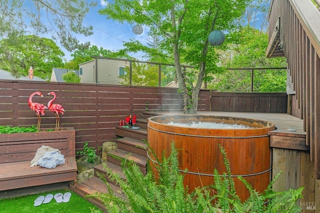 details featuring a hot tub and fence