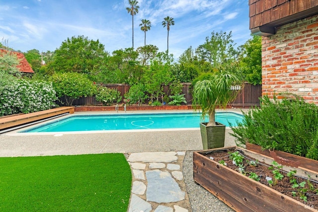 view of swimming pool with a fenced in pool and a fenced backyard
