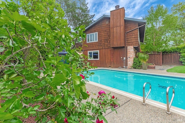 view of swimming pool featuring fence and a fenced in pool