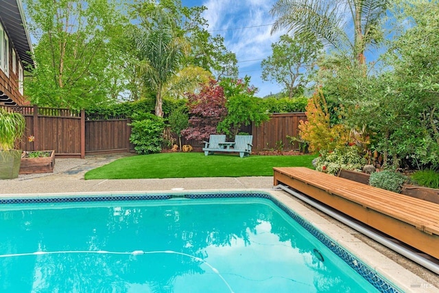 view of pool featuring a fenced backyard, a fenced in pool, and a yard