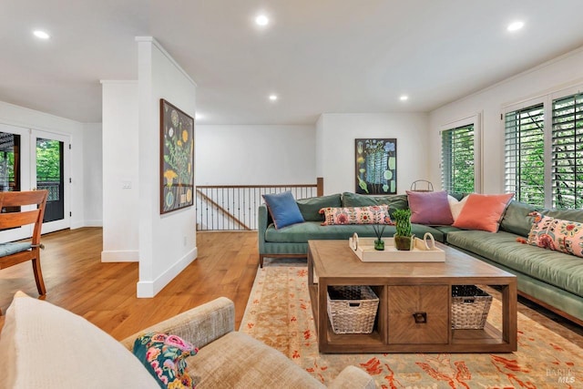 living area with recessed lighting, light wood-style flooring, and a wealth of natural light