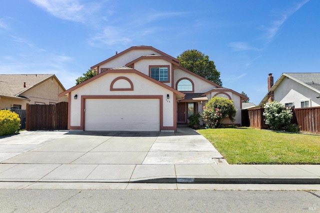 mediterranean / spanish-style house with stucco siding, fence, driveway, a front yard, and an attached garage