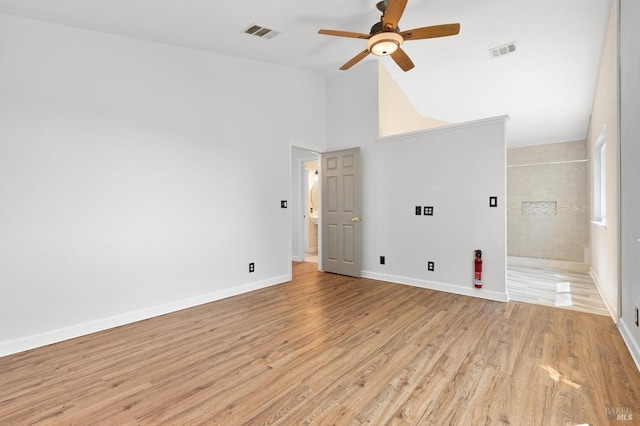 empty room with baseboards, visible vents, ceiling fan, and light wood-style flooring