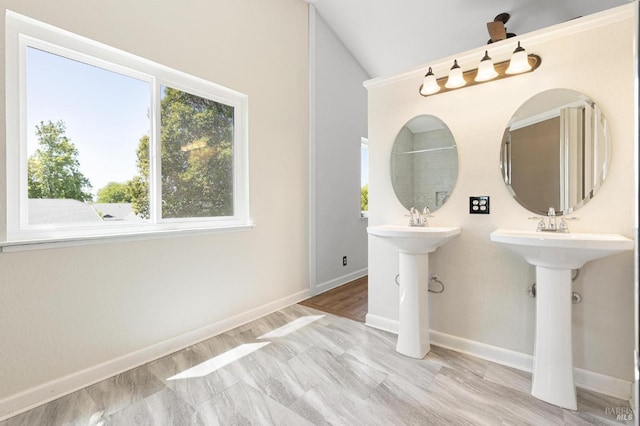 full bath with baseboards and vaulted ceiling