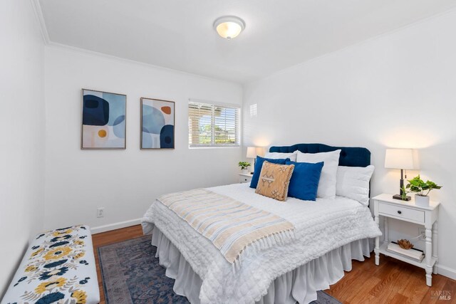 bedroom featuring baseboards and wood finished floors