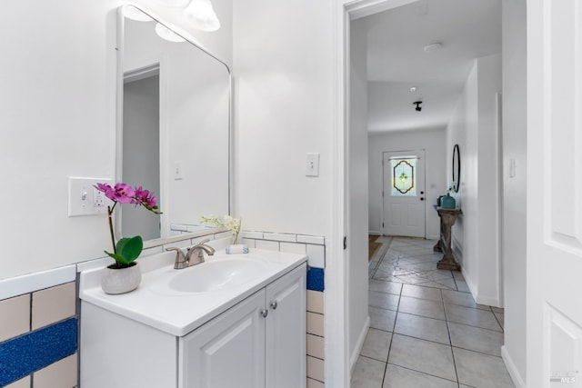 bathroom featuring vanity, tile patterned flooring, and baseboards