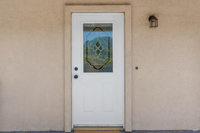 entrance to property with stucco siding