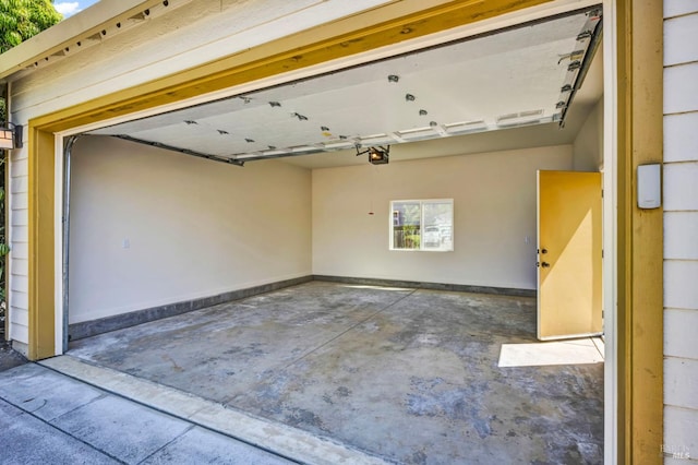 garage with baseboards and a garage door opener