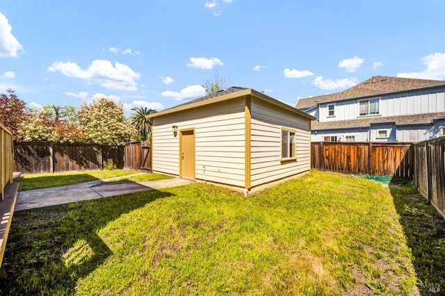 view of outdoor structure with an outbuilding and a fenced backyard