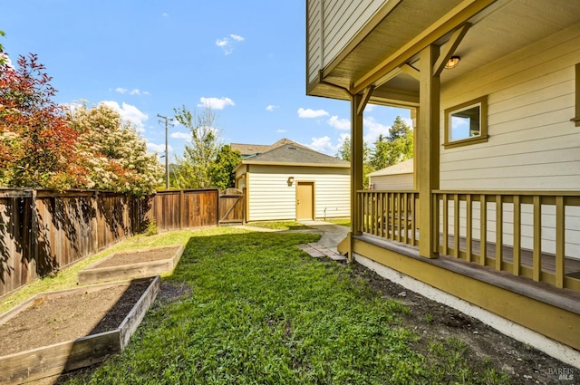 view of yard with a gate, a fenced backyard, and a vegetable garden