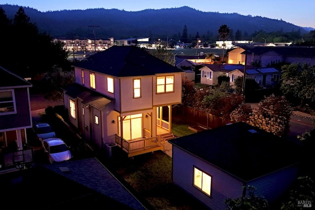 back of property at dusk featuring a mountain view