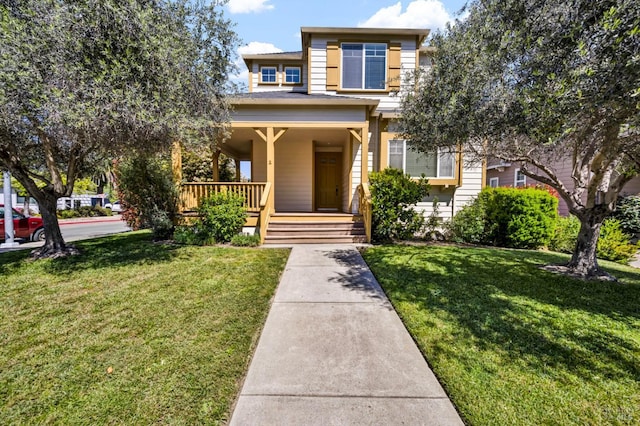 traditional-style house featuring covered porch and a front lawn
