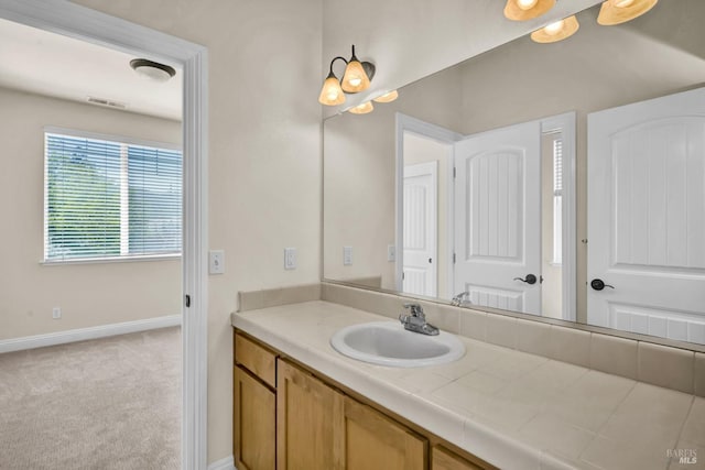bathroom with visible vents, vanity, and baseboards